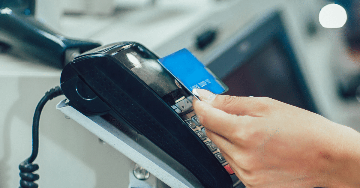 A person is using a credit card on a machine.