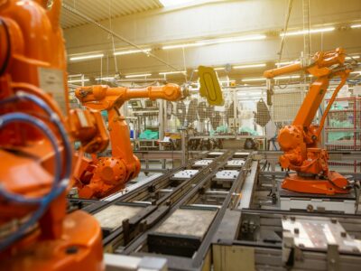 A discrete manufacturing assembly line with three orange robotic arms and other smart technologies on display