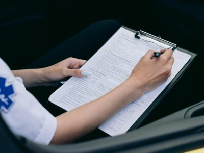 Healthcare professional in medical uniform filling out report, including HIPAA compliant information that will be submitted to an ERP such as Sage Intacct